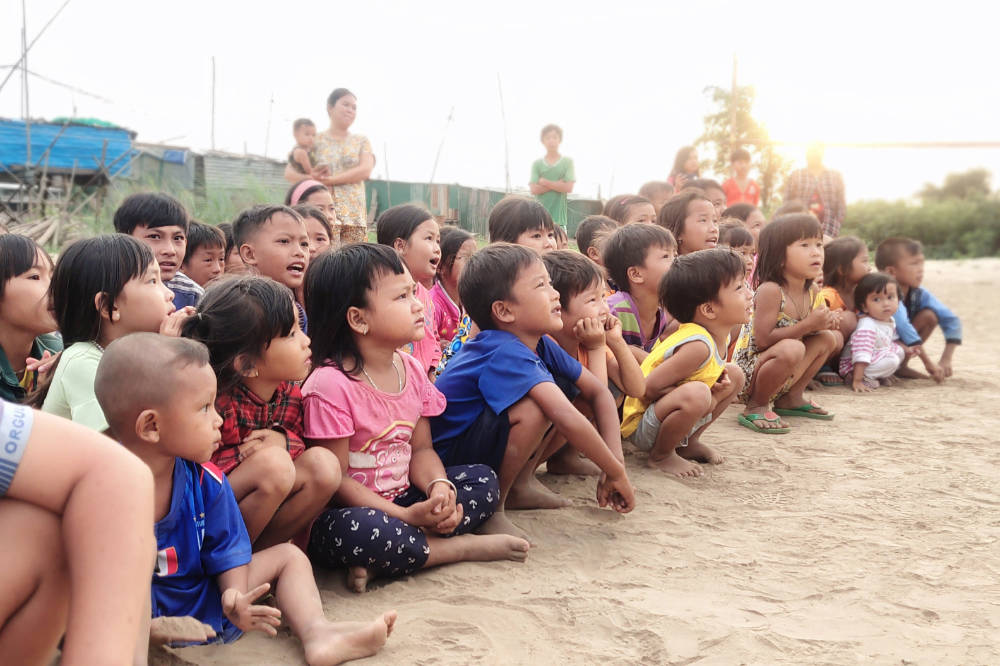 Children Listening on the Beach with Traveling Apostles